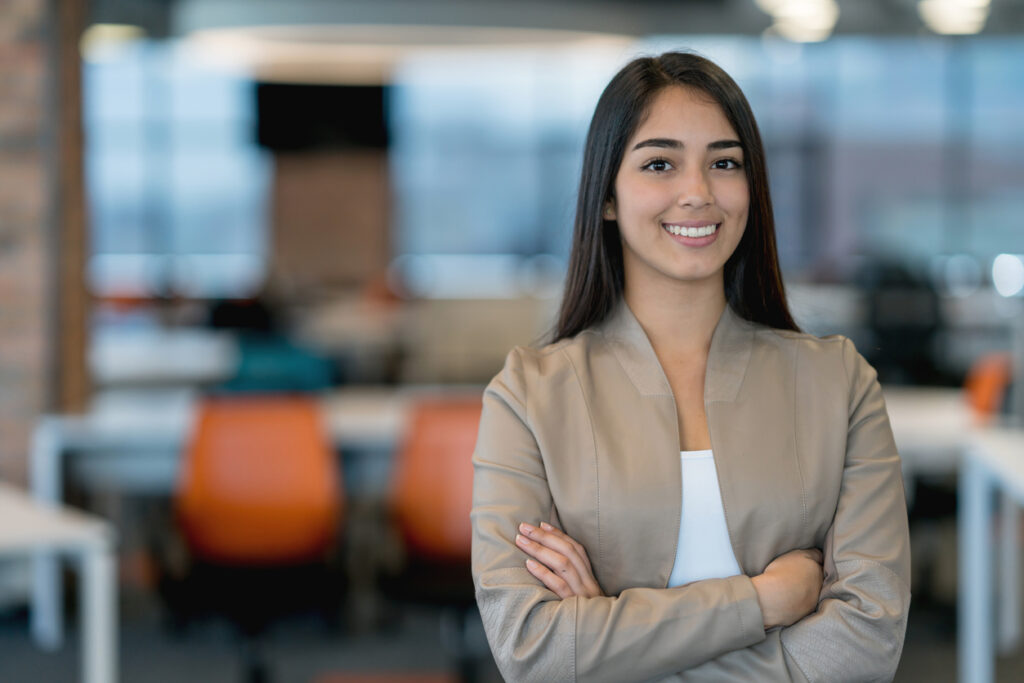 Portrait of a woman working at the office and looking at the camera smiling